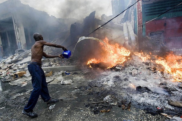 Man attempting to douse a fire Port-au-Prince after the 2010 earthquake